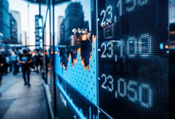 LED screen showing real-time stock market data and index prices in a financial district