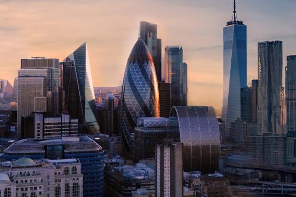 Modern city skyline at sunset with prominent office skyscrapers.