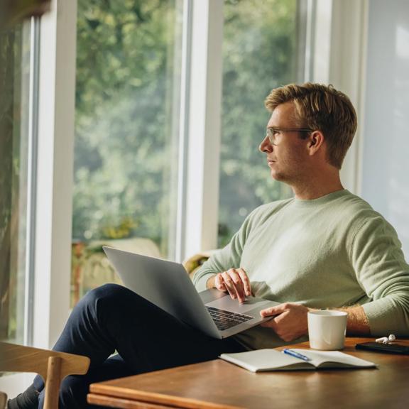 Professional using a laptop while working from home.