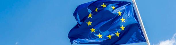European Union flag blowing in the wind, symbolizing European markets, policy, and governance