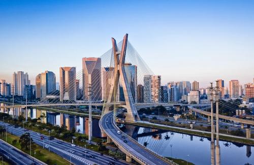 São Paulo skyline with Octavio Frias de Oliveira Bridge crossing the Pinheiros River surrounded by modern high-rise buildings