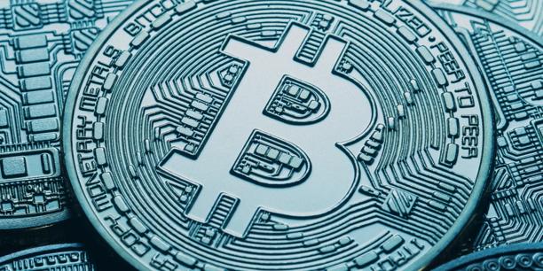 Close-up of a Bitcoin coin with a digital circuit pattern