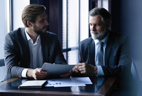 Business professionals discussing over tablet in office setting