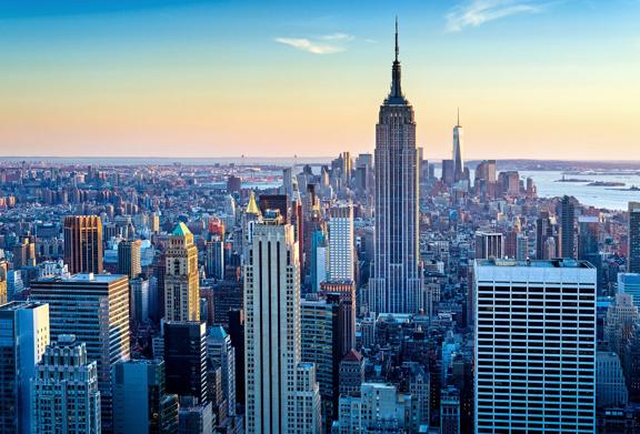 Aerial view of New York City with the Empire State Building, skyscrapers, and skyline at sunset