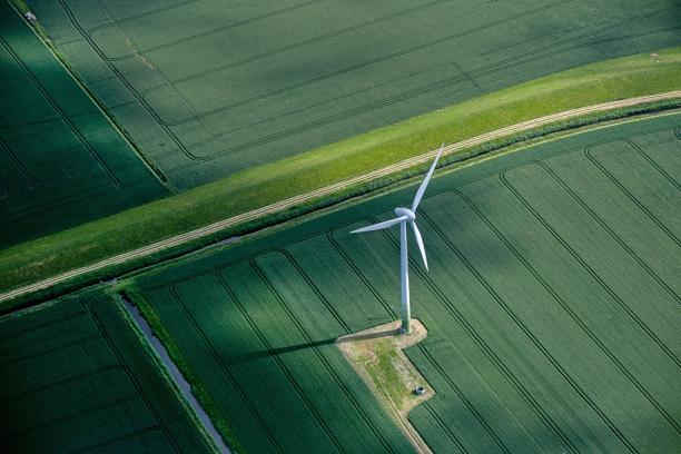 A single wind turbine in a green field