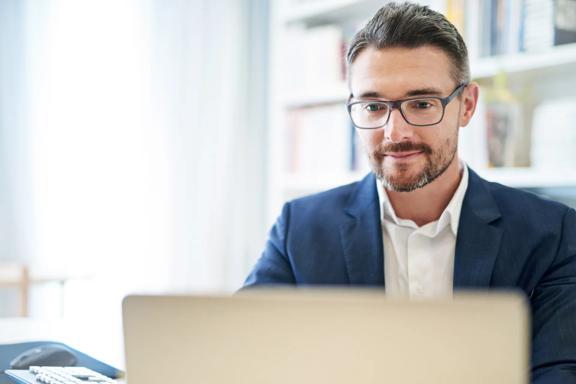 Professional trader working on laptop