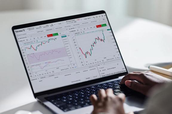 Trading platform with real-time market charts shown on a laptop during financial analysis.