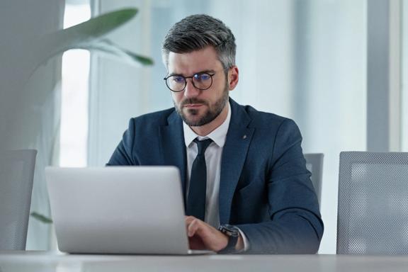 Business executive working on a laptop in a modern office