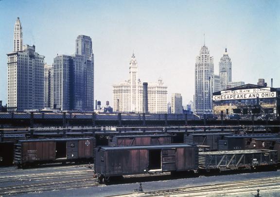 Vintage view of Chicago's skyline with historic skyscrapers and railroad tracks in the foreground.