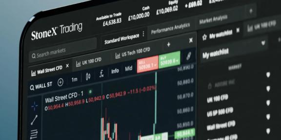 A laptop screen displaying the StoneX Market Intelligence dashboard