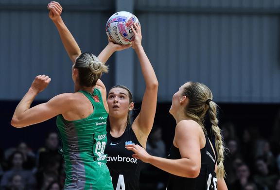 London Mavericks netball players competing under the post during a StoneX sponsored match