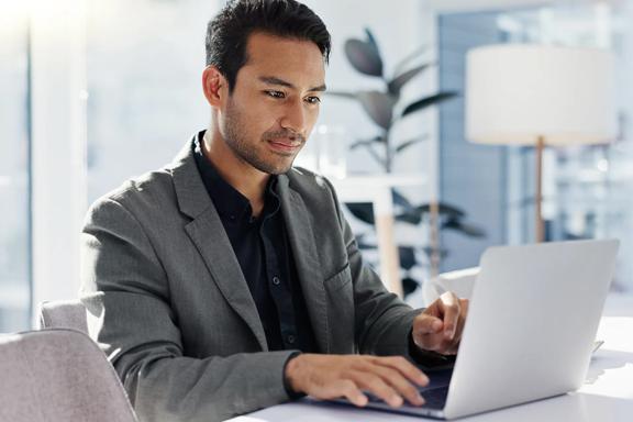 Professional using a laptop to monitor