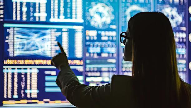 Finance expert analyzing repo and collateral market data on multiple monitors
