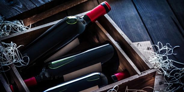 Bottles stored in a wooden box with protective packing material.