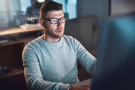 Trader practising on a demo trading platform using a desktop computer