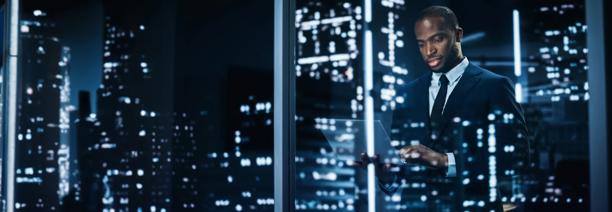 Professional man and skyscrapers at night