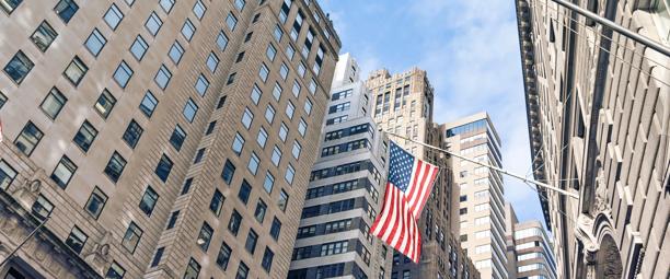 Wall Street buildings with U.S. flag representing U.S. custody solutions