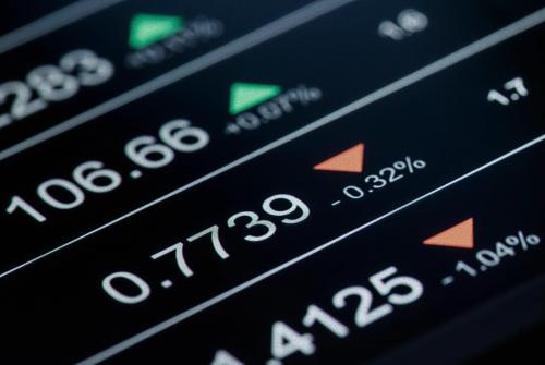 Close-up of live financial market prices showing rising and falling currency and trading values on a digital screen.