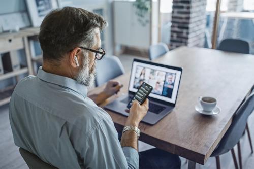 Man sitting at desk working on laptop 