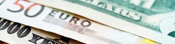 Close-up of euro banknotes with European Union flag, symbolizing Eurozone economy and currency markets